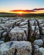 Sunrise over limestone pavement at Malham Lings, Yorkshire Dales, England. EL030