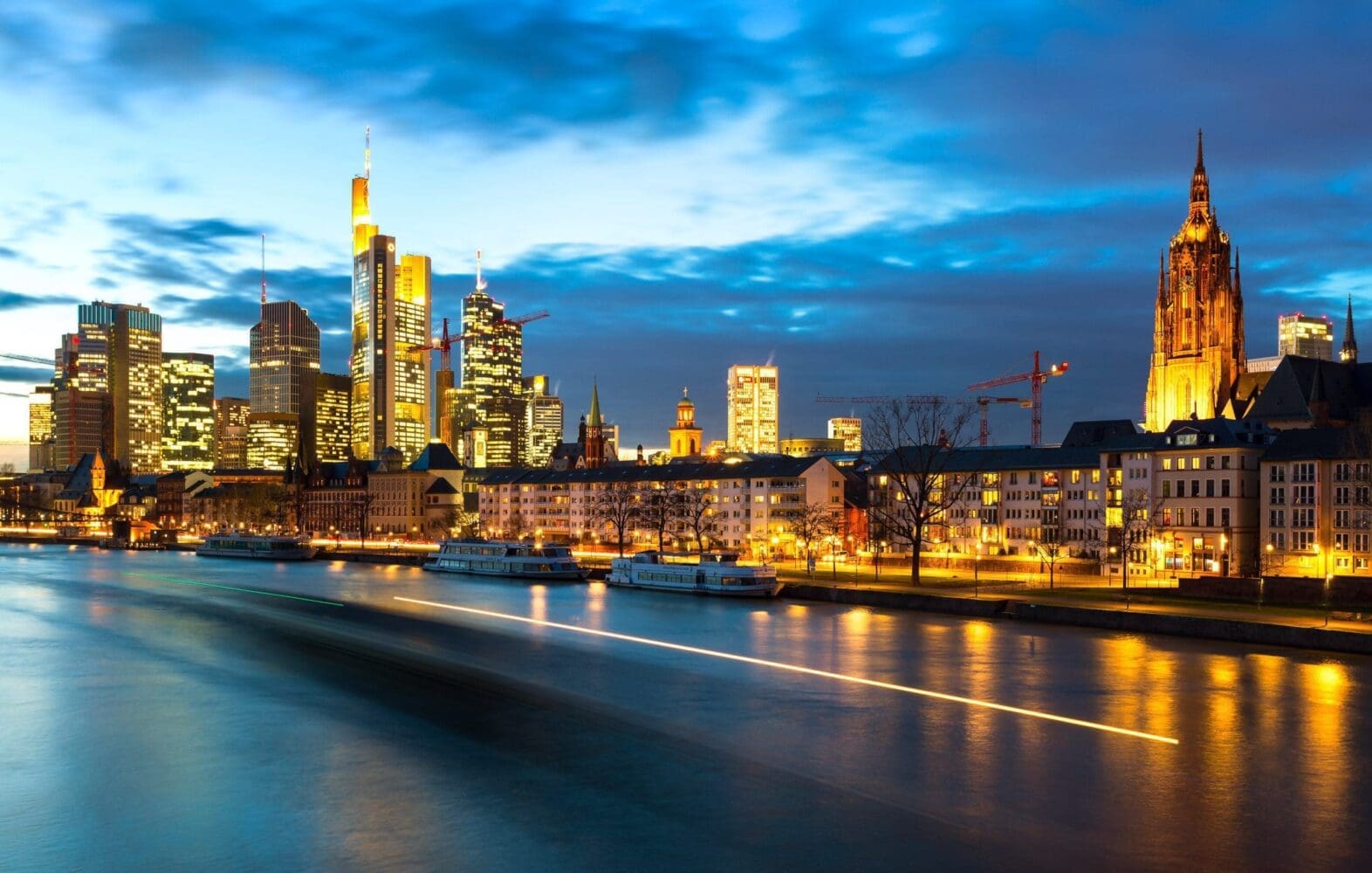 Dusk on the Main as a barge passes in Frankfurt am Main, Hesse, Germany FF021