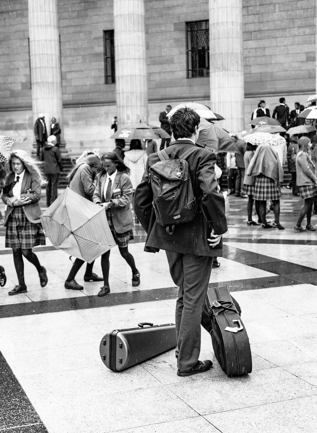 Monochrome (black and white) image of a pupil of Dundee High School in City Square, Dundee after the school's graduation ceremony in the Caird Hall. DD008