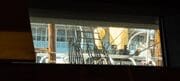 View of the RRS Discovery through a rectangular window of the V&A building in Dundee, Scotland. DD182