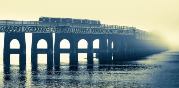 Duotone of train crossing the Tay Rail Bridge in fog, Dundee, Scotland. TO001