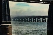 The central arches of the Tay Rail Bridge framed by pillars at the Dundee end, Scotland. DD081