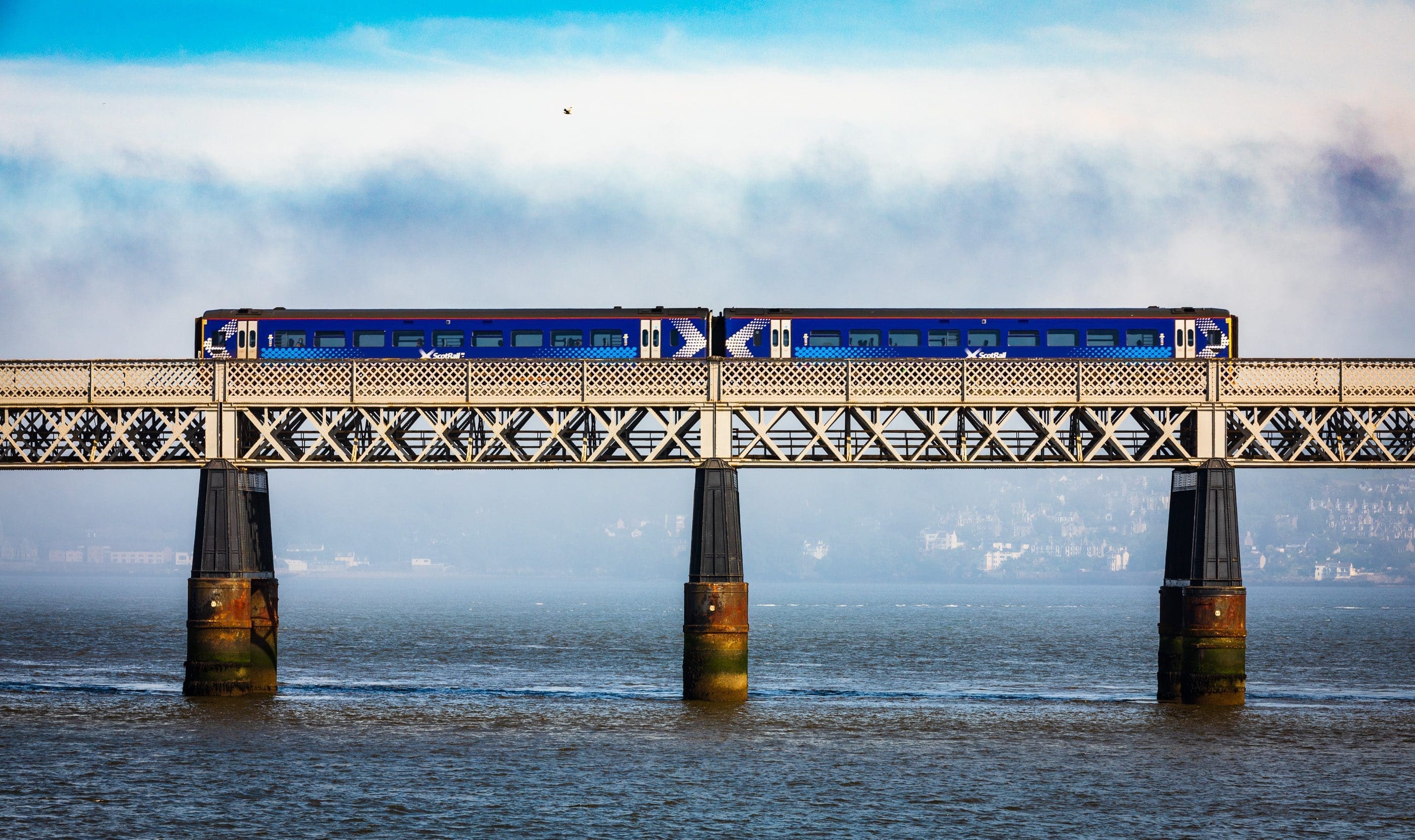 Train crossing the Tay Railway Bridge in fornt of a fog-bank, Dundee, Scotland. DD083