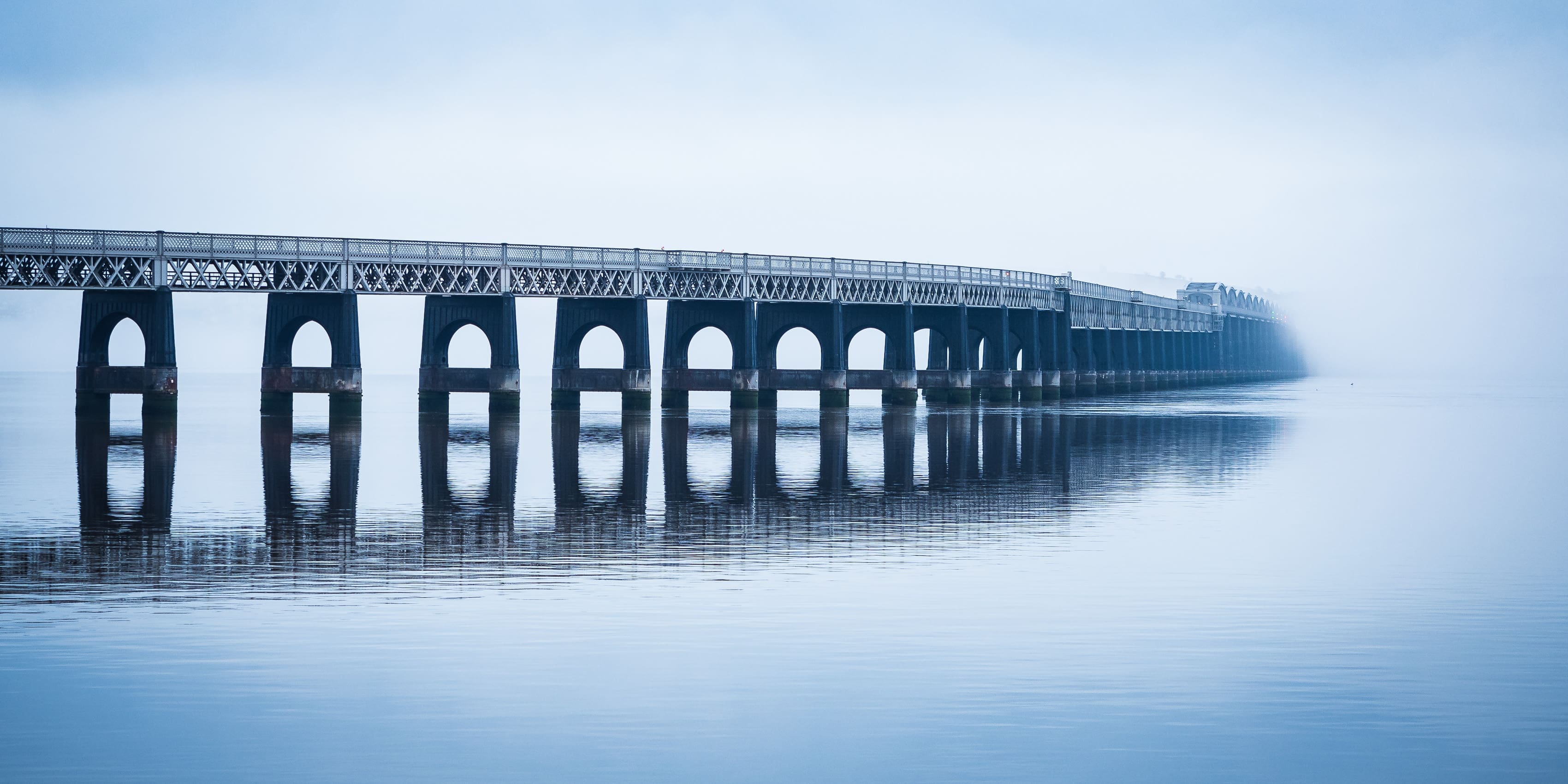 The Tay Railway Bridge in fog, from Dundee, Scotland.