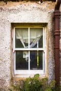 Curtained window of an abandoned croft house, near Callakille, Scotland. AP020