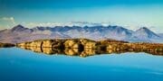 The Cuillins of Skye viewed from a lochan near the Bealach na Ba, Applecross, Scotland. AP014