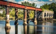 Long exposure image of the disused stone and cast-iron railway bridge over the River Blackwater at Cappoquin, County Waterford, Ireland. BW022