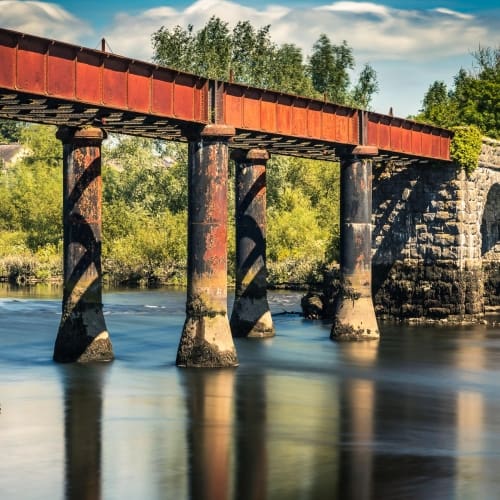 Long exposure image of the disused stone and cast-iron railway bridge over the River Blackwater at Cappoquin, County Waterford, Ireland. BW022