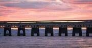 Train passing over the Tay Railway Bridge at sunset, Dundee, Scotland. DD156