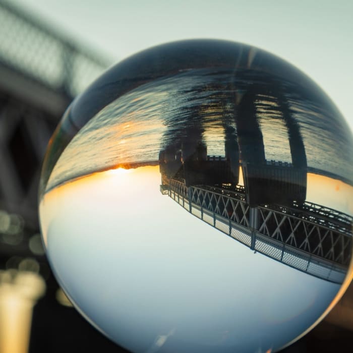 Tay Railway Bridge reflected in glass sphere, Dundee, Scotland.