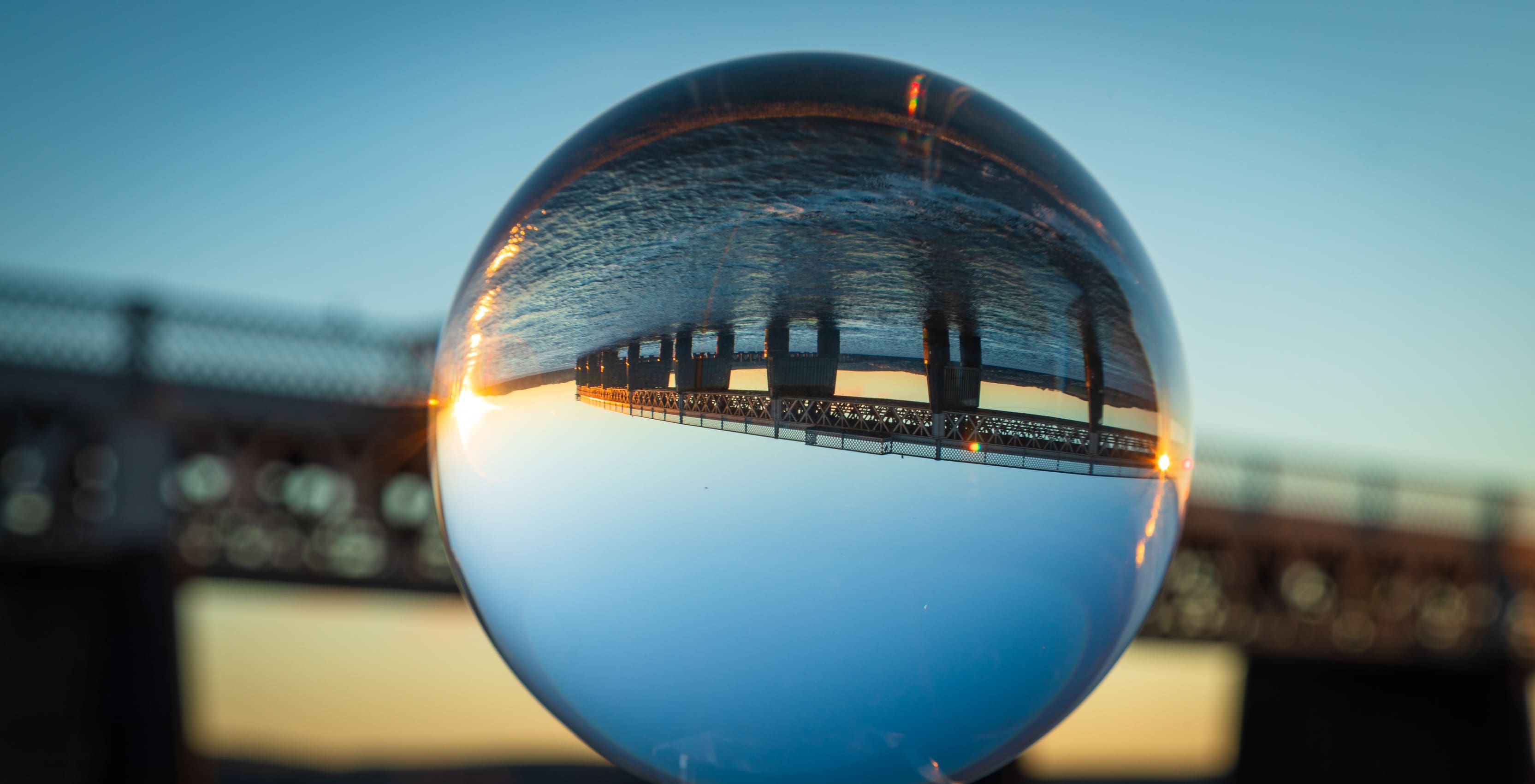 Tay Railway Bridge reflected in glass sphere, Dundee, Scotland.